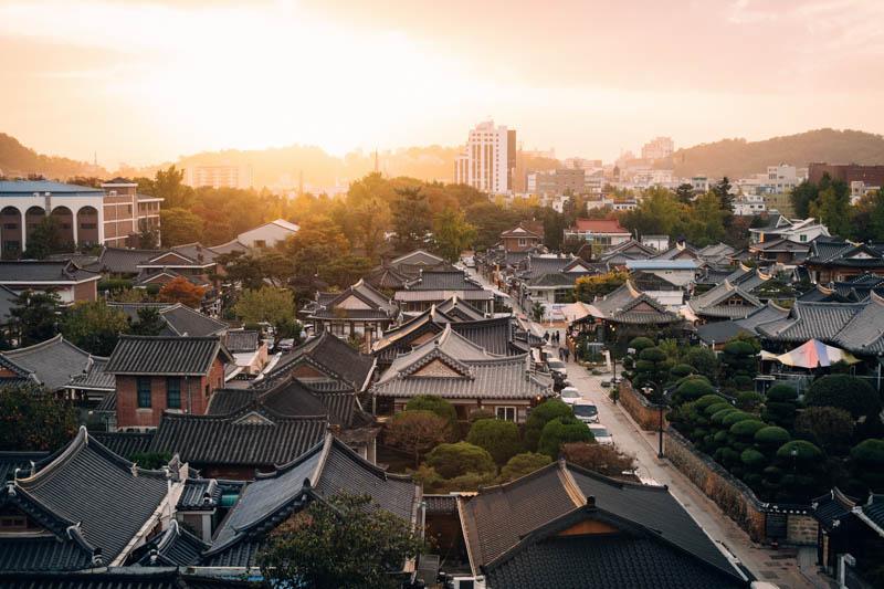 Aerial view of rooftops in a traditional village in South Korea during sunset.