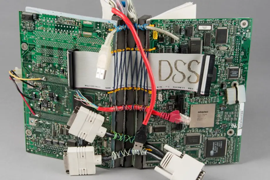 Book cover made from discarded electronic materials such as wires, circuit boards, and connectors.