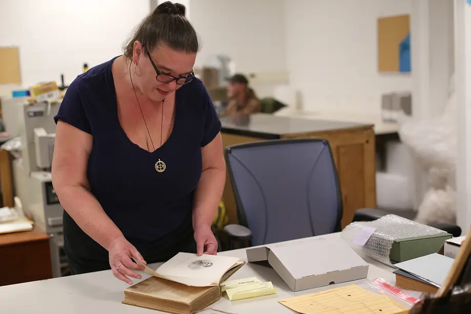 Lara Unger leafs through a book signed by Susan B. Anthony.