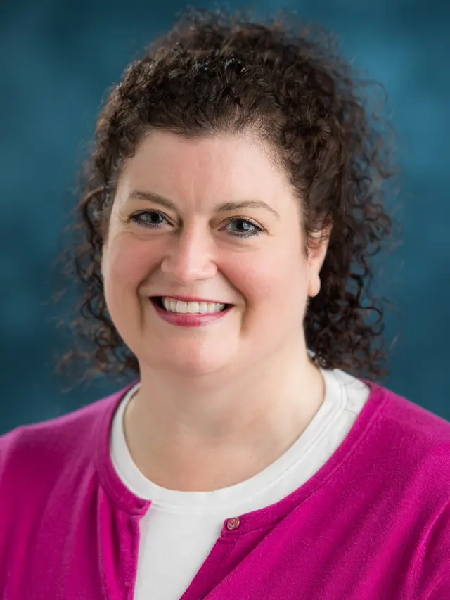 Picture of Jo Angela Oehrli wearing a cranberry cardigan with a white shirt.