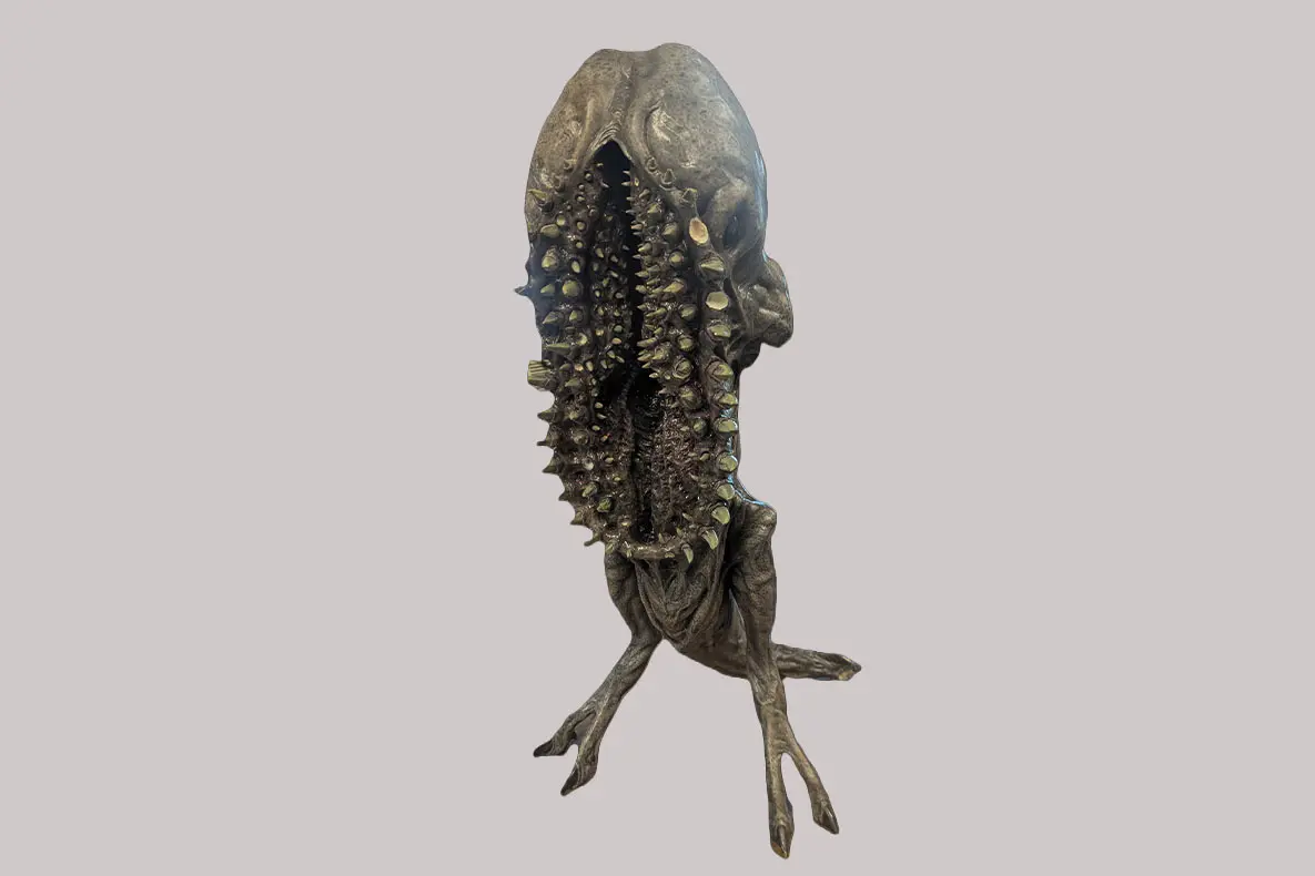 Creepy monster with a gaping mouth full of multiple rows of teeth.