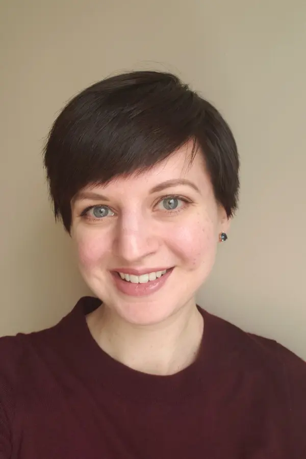 Photograph of Heather Shoecraft, a white woman with short, brunette hair, wearing a maroon sweater and smiling.