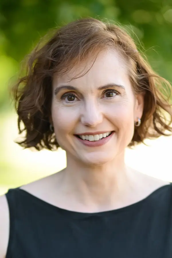 Melissa Stewart, a white woman with short brown hair wearing a black shirt.