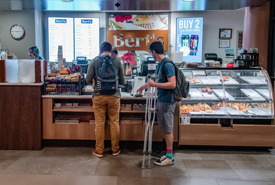 Two students ordering at Bert's Cafe in the Shapiro Library.