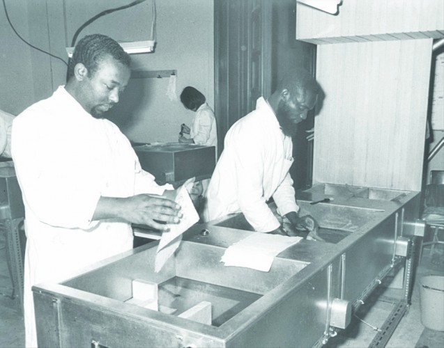 Joe Nkrumah and a colleague washing book leaves in the new washing sinks