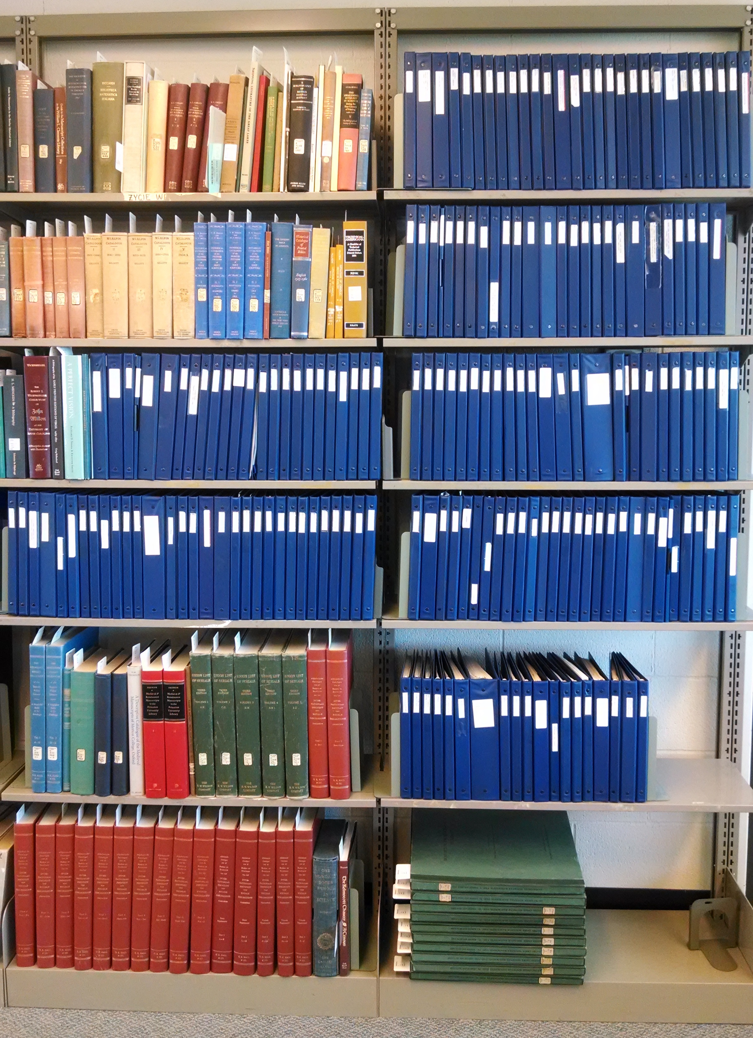 Blue binders on shelves in Reading Room