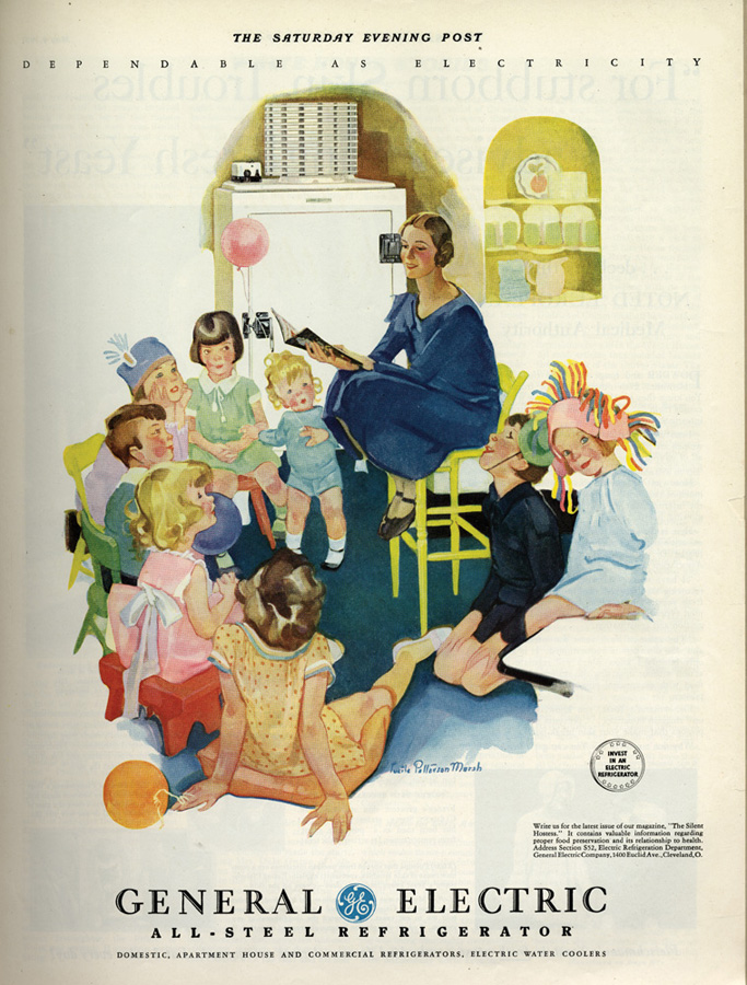 A group of children sitting around a woman on a stool who is reading to them, with a nineteen-thirties refrigerator in the background