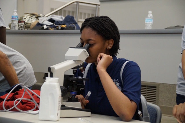 Image of student using microscope