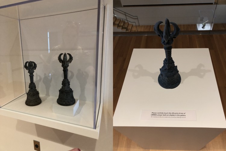 A side-by-side image of prayer bells, the one on the left being the original, and the one on the right being a 3D-printed replica, with a sign encouraging people to carefully touch the replica. 