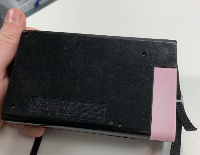 Image of a pink 3D-printed battery cover for a Walkman