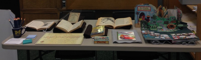books, boardgames, and maps on display for "Journeys, Real and Imagined" pop-up exhibit