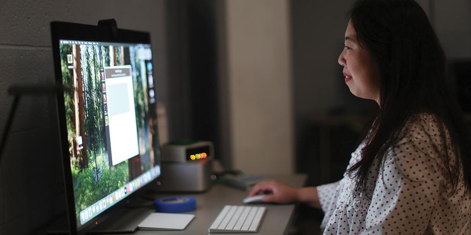 Photo of Abby Sypniewski looking at a computer screen