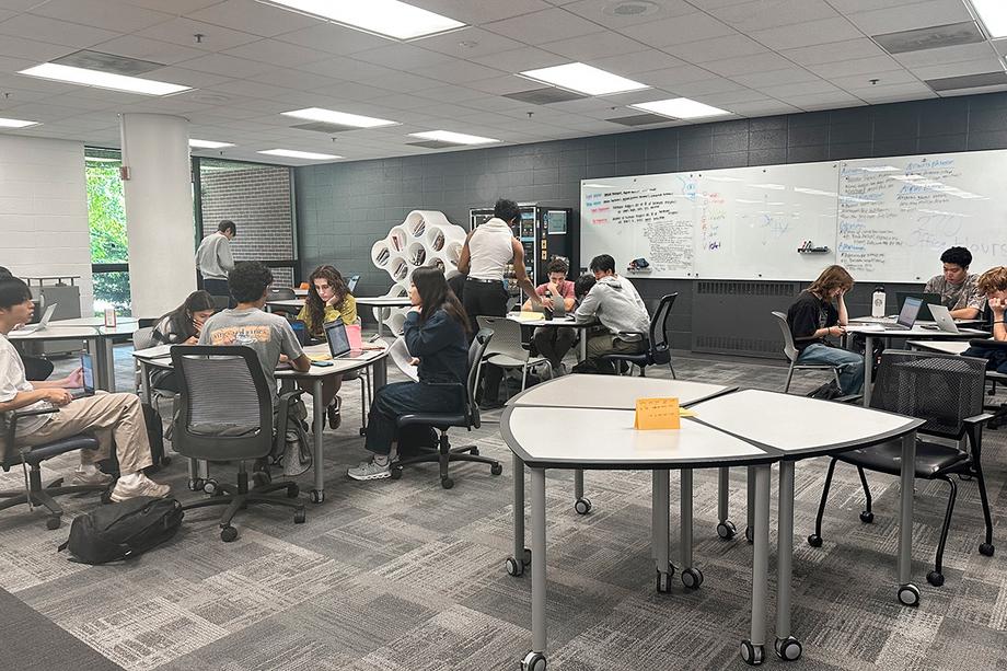 Groups of students working together on creative projects.