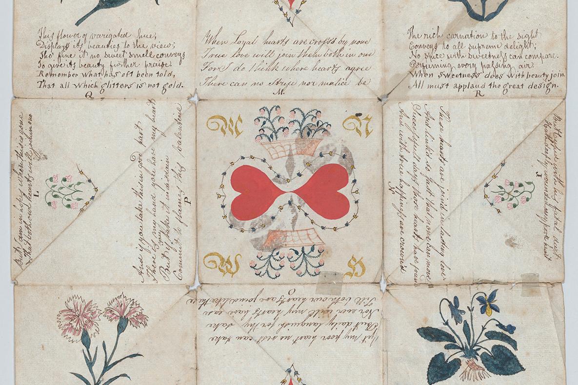 Paper sheet with text and folds, showing two hearts at the center.