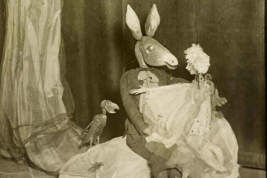 Puppets from Midsummers Night's Dream posed in a scene on stage