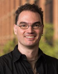 Photograph of Scott Martin: a white man with glasses, in front of a window.