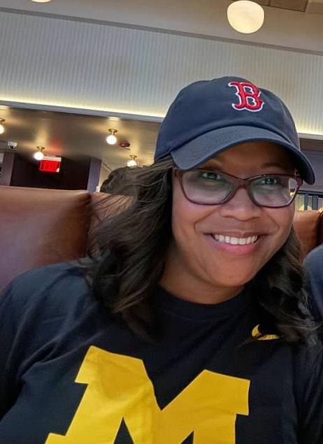 Black woman wearing an M Block T-shirt