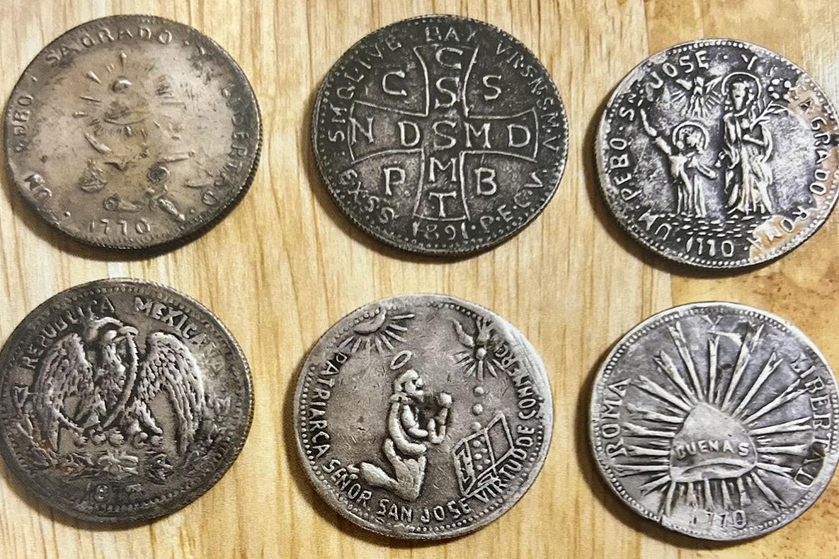Six round metal amulets.