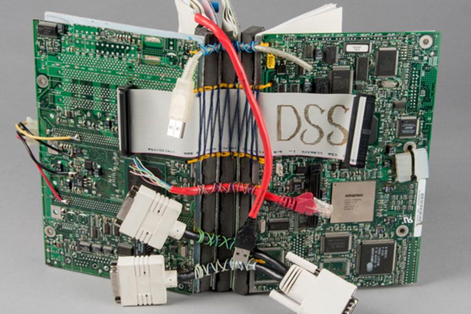 Book cover made from discarded electronic materials such as wires, circuit boards, and connectors.