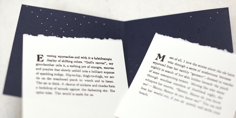 Two white sheets of printed paper displayed against a dark blue folder.