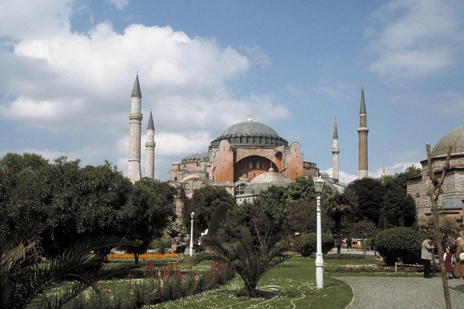 Exterior view of the Hagia Sophia against a blue sky with a few clouds.