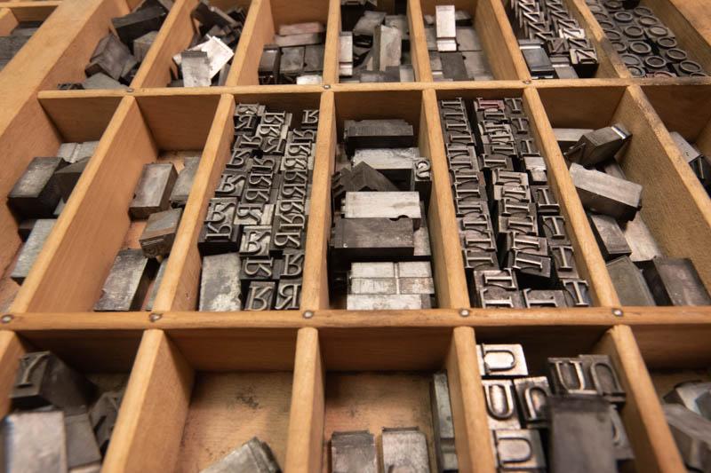 Drawer with dividers holding various letter blocks to be used by a letterpress.