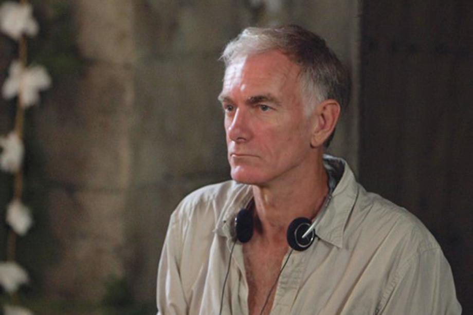 Director John Sayles with headphones around his neck.