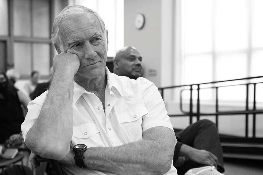 Director John Sayles, sitting in the Hatcher Library Gallery and propping his head on his fist.