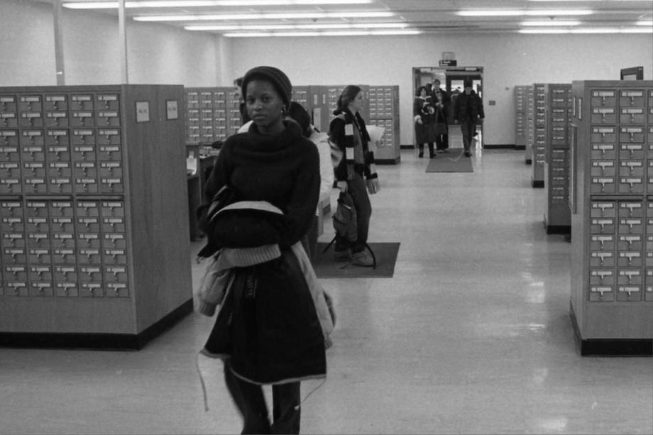 passageway with people walking, lined with card catalogs 