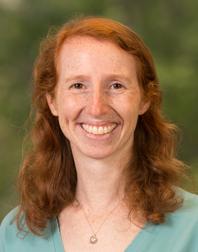 Marci Brandenburg&#039;s Photo. Female with red hair a little beyond shoulder length, smiling, wearing a light blue shirt.