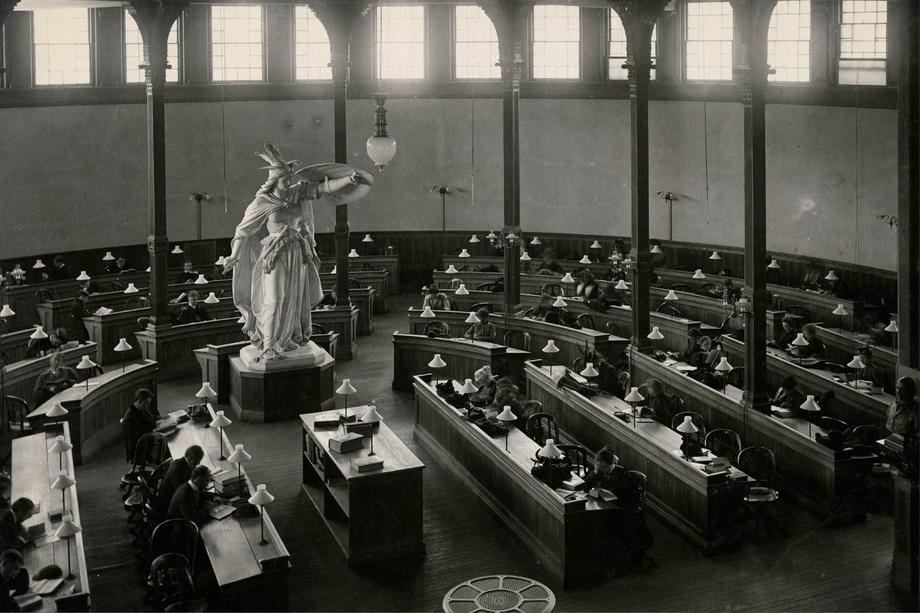 round reading room with a large winged statue in center