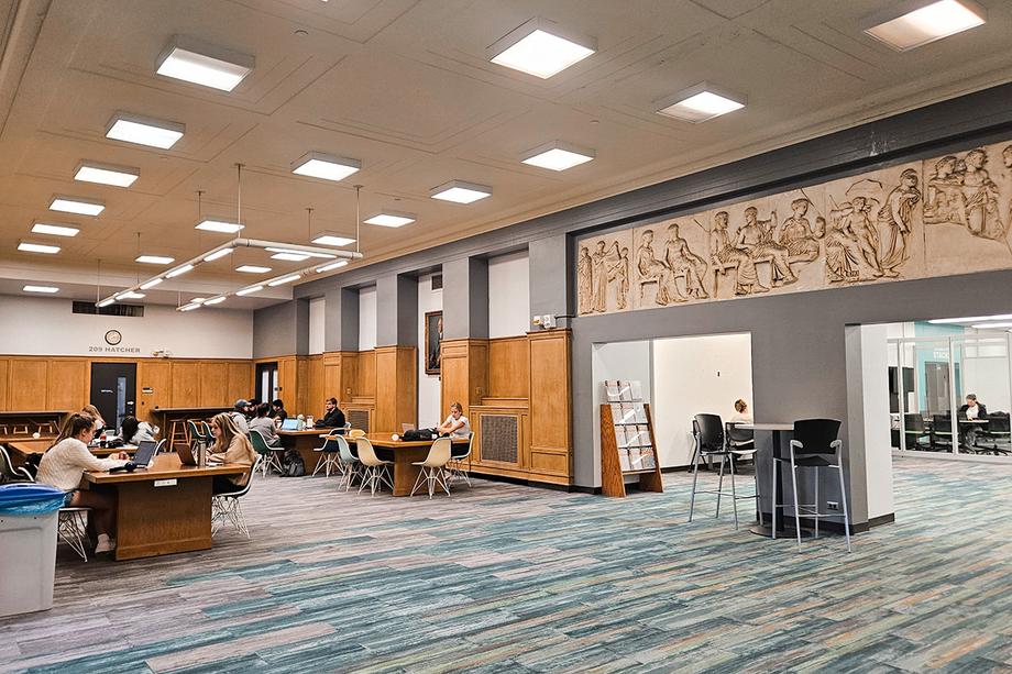 Open, high traffic area with large tables on the side for studying.