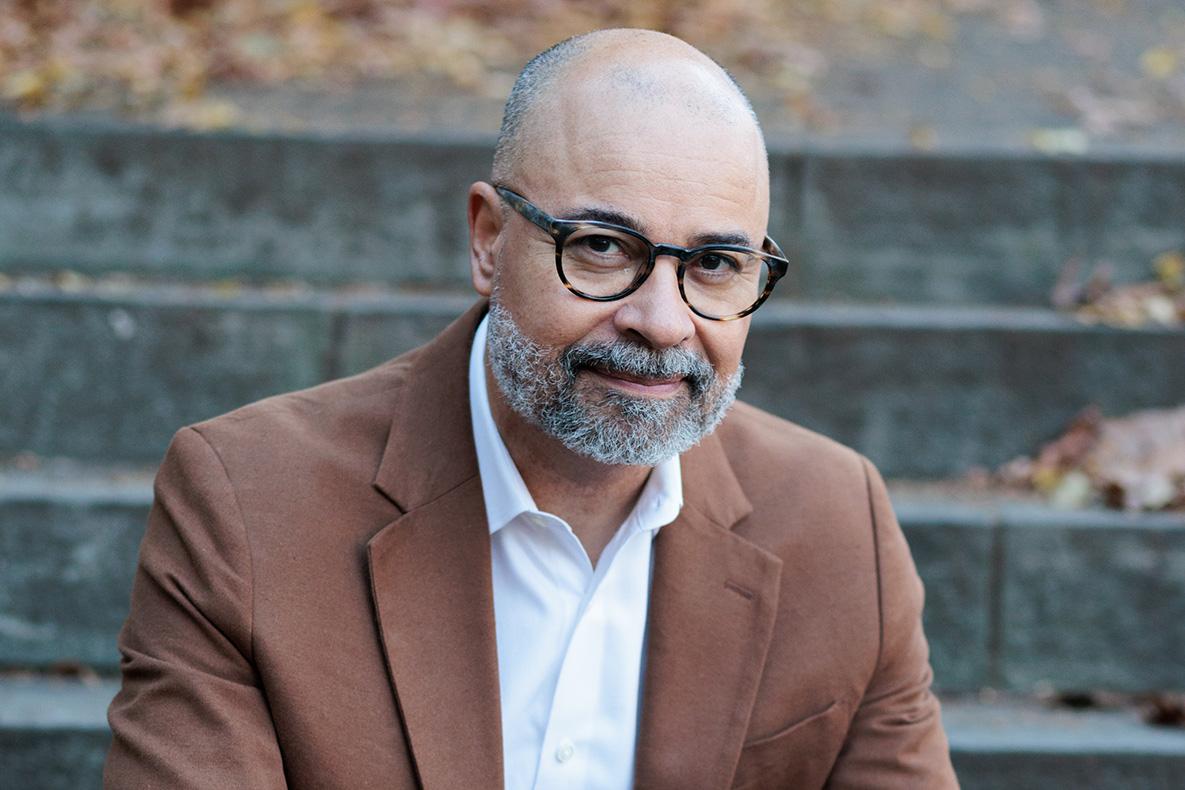Headshot  of a man wearing glasses.