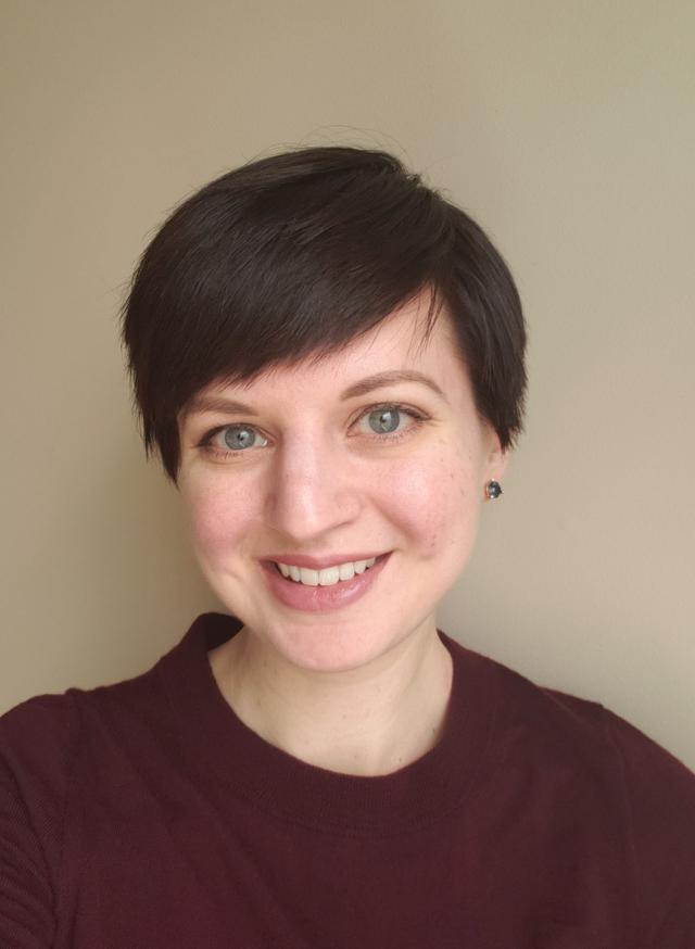 Photograph of Heather Shoecraft, a white woman with short, brunette hair, wearing a maroon sweater and smiling.