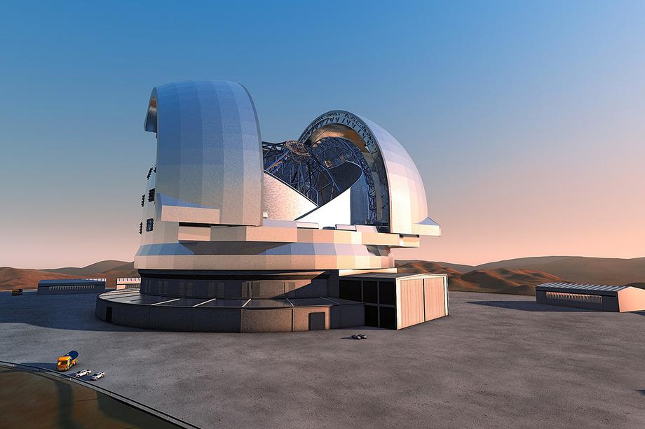 Huge telescope built into an open dome with a blue and red sky in the background.