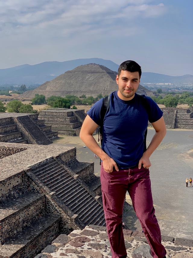 Picture of Jesus Espinoza standing in front of pyramids in Mexico